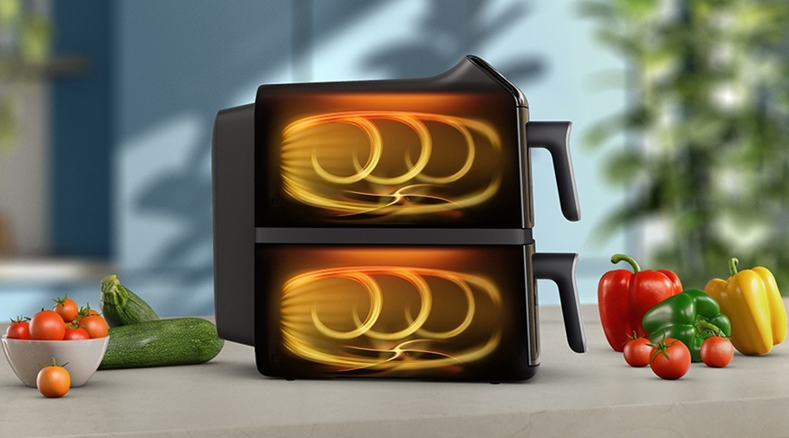 Fritéza horkovzdušná Philips Airfryer Dual Basket 4000 series 10 l, NA461/00 černá Horkovzdušná fritéza Philips NA461/00 se dvěma koši zobrazená z boku, s grafickým znázorněním proudění horkého vzduchu v obou komorách, vedle spotřebiče jsou na kuchyňské lince čerstvá zelenina.