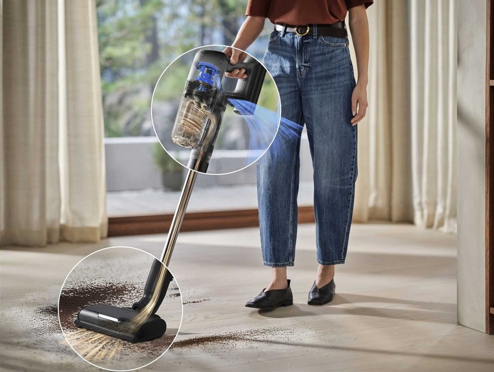 Tyčový vysavač Electrolux 700 Hygienic EP72H21WET modrý Žena vysává vysavačem Electrolux koberec v obývacím pokoji.