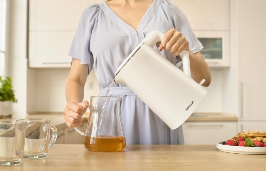 Žena používající dvoustěnnou rychlovarnou konvici  Sencor SWK 0550WH s objemem 1,7 l