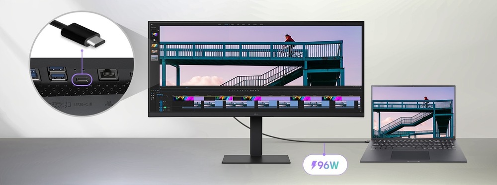 Velký monitor připojený k notebooku zobrazuje časovou osu střihu videa. Detailní záběr ukazuje připojení USB-C. Text označuje nabíjení o výkonu 96 W.
