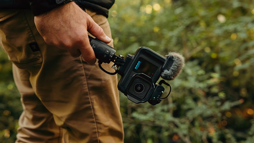 Stativ GoPro Volta 2.0 černý Uživatel při chůzi přírodou nese v ruce akční kameru upevněnou na gripu Volta 2.0