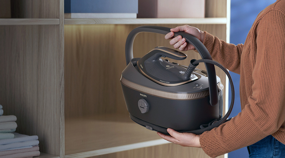 Žena přenáší žehlicí systém Philips PSG8200/80 8000 Series