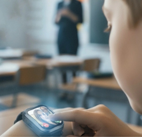Chytré hodinky Carneo GuardKid+ 4G ULTRA 2nd gen. růžové Dítě komunikující pomocí hodinek ve školním prostředí.