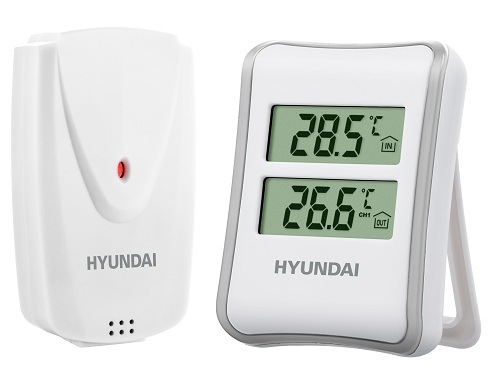 Bílá meteostanice Hyundai WS 1030 zobrazující naměřenou vnitřní a venkovní teplotu s externím bezdrátovým čidlem