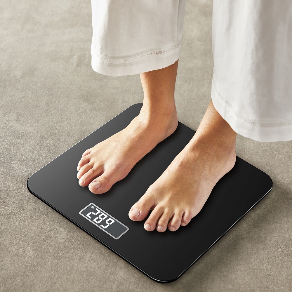 Muž stojí na černé osobní váze Tefal PP1800V0 Premiss