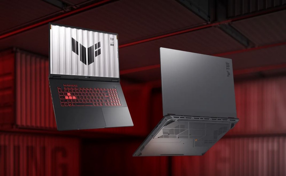 Notebook Asus TUF Gaming A18 šedý Dva notebooky – jeden viděný z přední a druhý ze zadní strany plují na červeném průmyslovém pozadí.