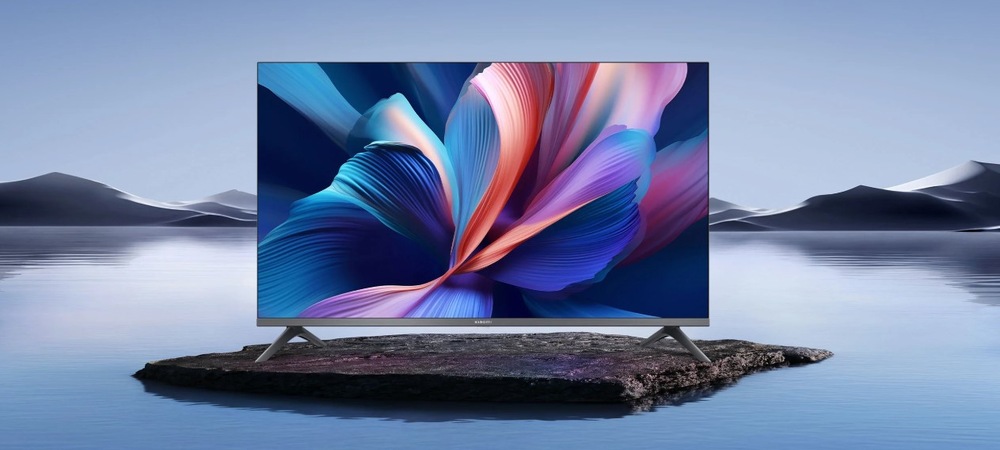 Televize Xiaomi TV A Pro 32" Televize Xiaomi TV A Pro 32" na kamenu ve voně s pozadím hor