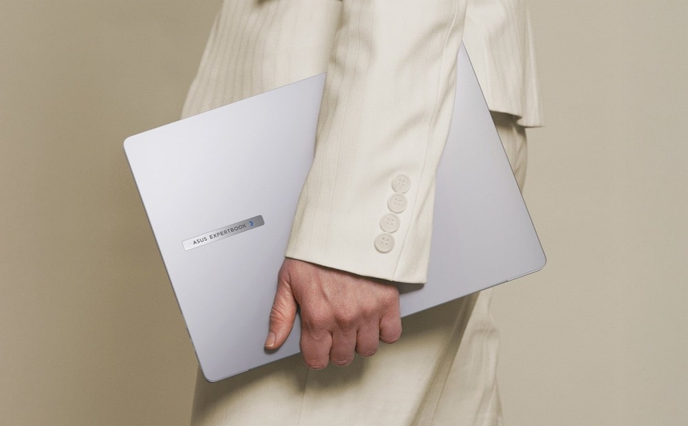 Notebook Asus ExpertBook P3 G2 šedý Osoba nesoucí notebook Asus ExpertBook P3 G2 pod paží