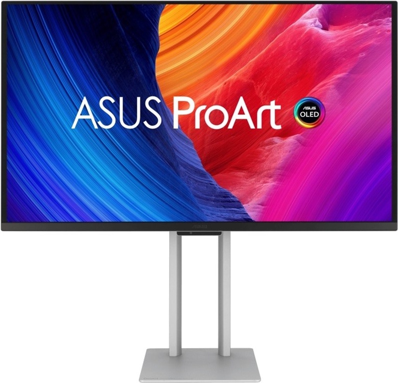 Na obrázku je monitor Asus ProArt OLED PA27UCDMR s úhlopříčkou 27". Je zobrazený z čelního pohledu na stříbrném stojanu s hranatou základnou. Displej má tenký černý rámeček a na obrazovce je barevná grafika s nápisem ASUS ProArt a označením OLED. Obraz kombinuje výrazné modré, oranžové, červené a fialové tóny, což zdůrazňuje zaměření monitoru na práci s obrazem, grafikou a přesnými barvami.