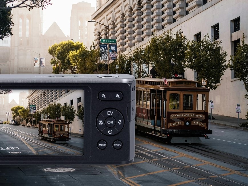 Digitální fotoaparát Rollei Compactline 12X černý Jedoucí tramvaj a její fotografie na displeji fotoaparátu Rollei Compactline 12X se stabilizací obrazu