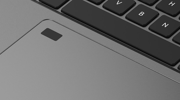 Notebook Acer TravelMate P2 (TMP216-71-G3-TCO-53AR) šedý Detailní záběr na elegantní šedý touchpad a klávesnici notebooku. V pravém horním rohu je vidět část klávesnice s klávesami H, V a B.