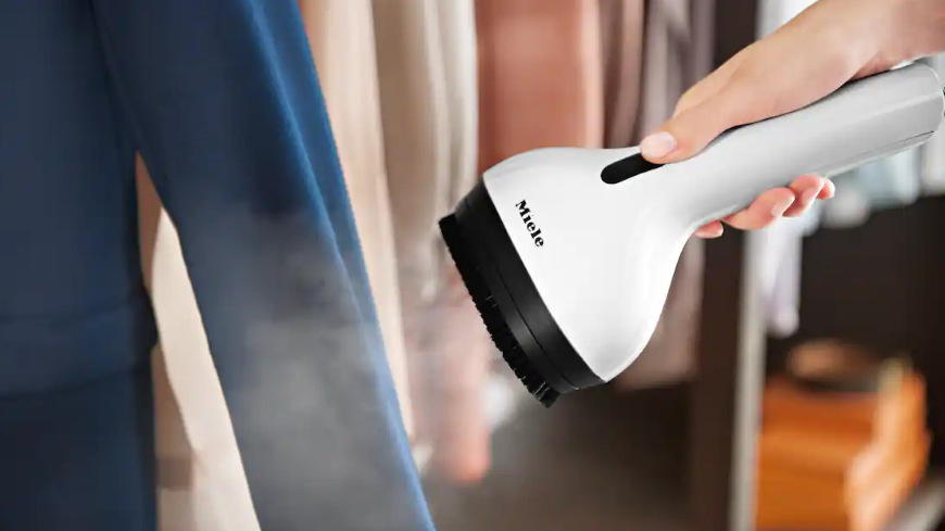 Žehlicí systém Miele B4847 FashionMaster 4.0 Ženská ruka používá napařovací systém Steamer