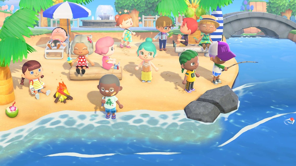 Záběr ze hry Animal Crossing: New Horizons. Živá plážová scéna zobrazuje postavy, které odpočívají, povídají si, rybaří a lenoší pod slunečníkem, čímž navozují radostnou atmosféru společenství.