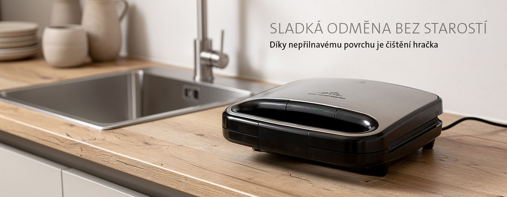 Vaflovač ETA Barres 5163 90000 nerez Zavřený nerezový vaflovač ETA Barres na dřevěné kuchyňské lince vedle dřezu. Text: Sladká odměna bez starostí. Díky nepřilnavému povrchu je čištění hračka