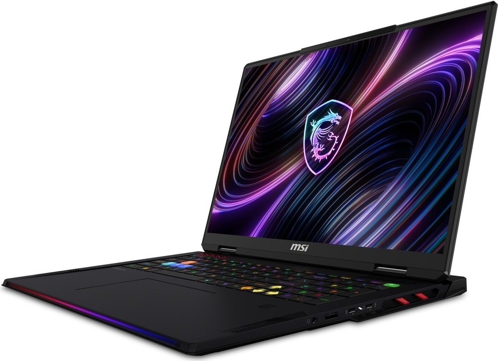 Notebook MSI Raider 18 Max HX A2WI-1042CZ černý Herní notebook MSI Raider 18 Max HX A2W z předního bočního úhlu s rozsvíceným displejem, RGB klávesnicí a světelnou lištou na přední hraně