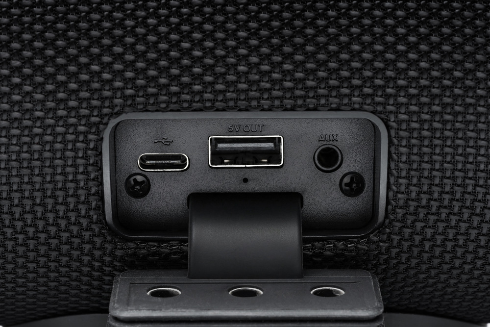 Detail konektorové výbavy černého přenosného reproduktoru JVC XS-E425B – USB, USB-C a AUX vstup pod krytkou