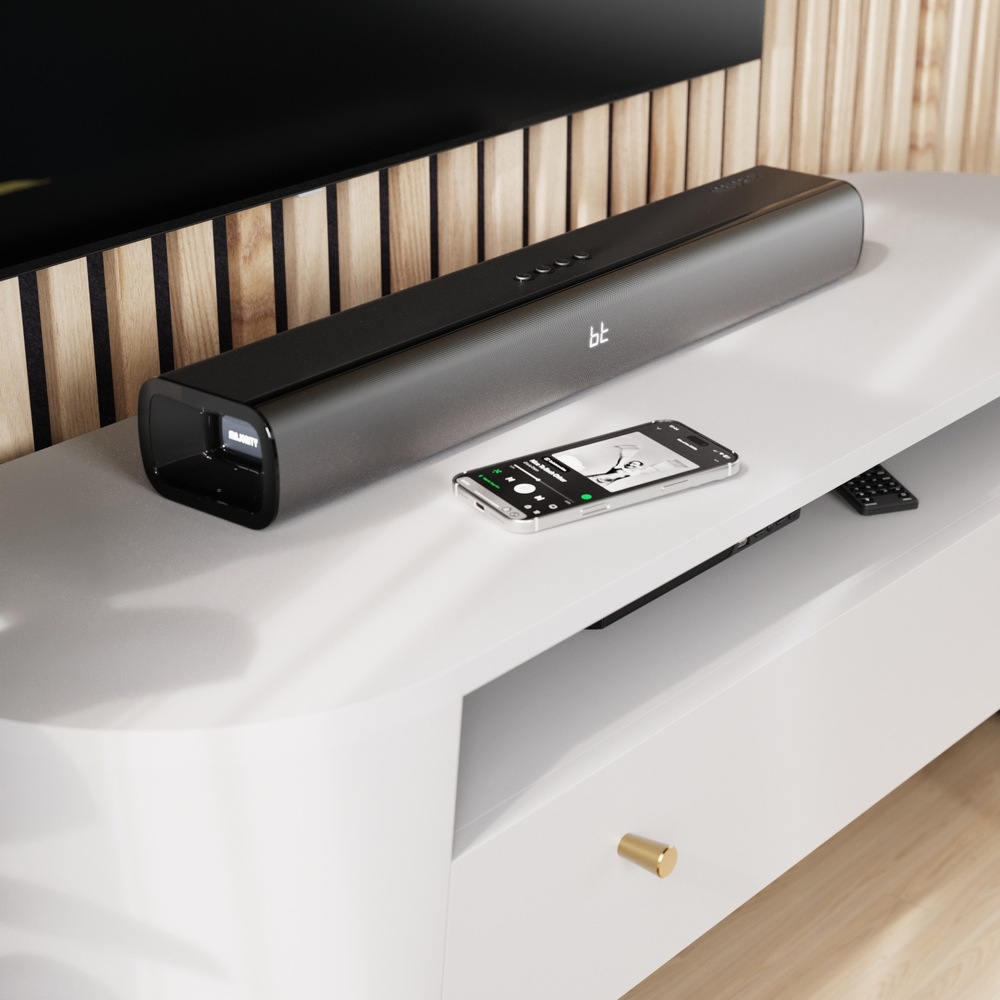 Soundbar Majority Naga 60 Plus umístěný pod televizorem, bezdrátově přehrávající hudbu z telefonu.