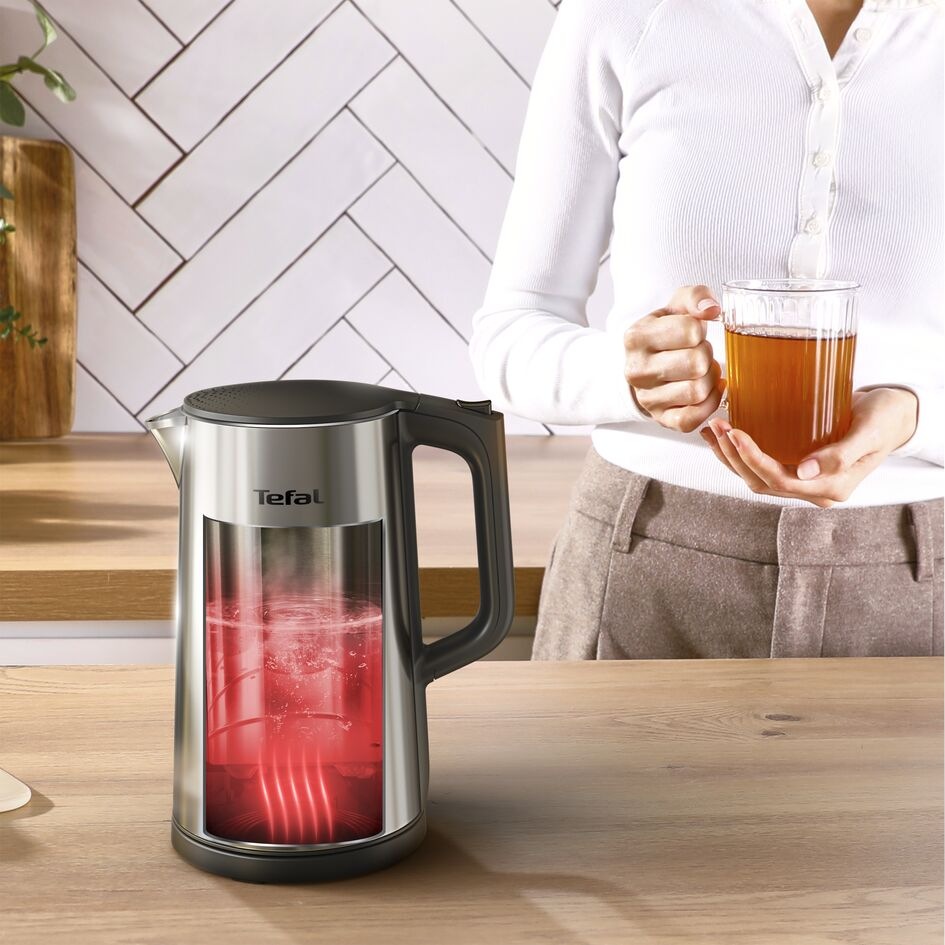 Žena drží v rukou čaj a před sebou má konvici Tefal KI871DE0 Selection s funkcí udržení teploty