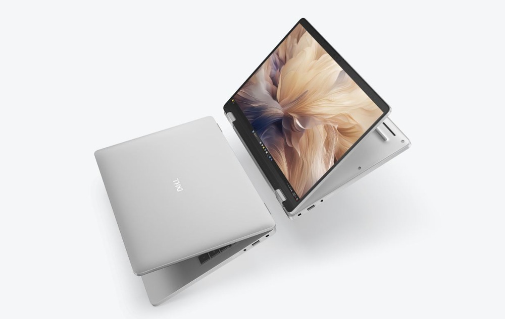 Notebook Dell Pro 14 Plus PB14255 stříbrný Dva stříbrné notebooky ve tvaru písmene V na bílém pozadí. Na obrazovce jednoho z nich je zobrazeno abstraktní umění.