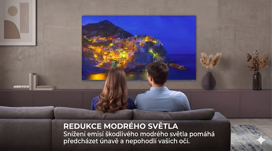 pár v obýváku hledí na televizi haier, kde se promítá večerní scéna