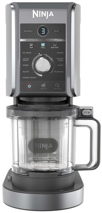 Zmrzlinovač Ninja Creami Deluxe na kuchyňské lince s připravenou zmrzlinou, sušenkami a kopečkem v kornoutu
