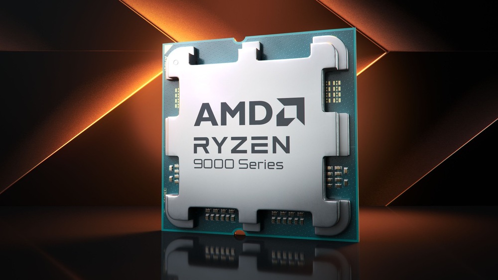 Čip AMD Ryzen řady 9000 na tmavém geometrickém pozadí s oranžovými akcenty. Kovový povrch čipu odráží světlo a vyjadřuje pokročilou technologii.